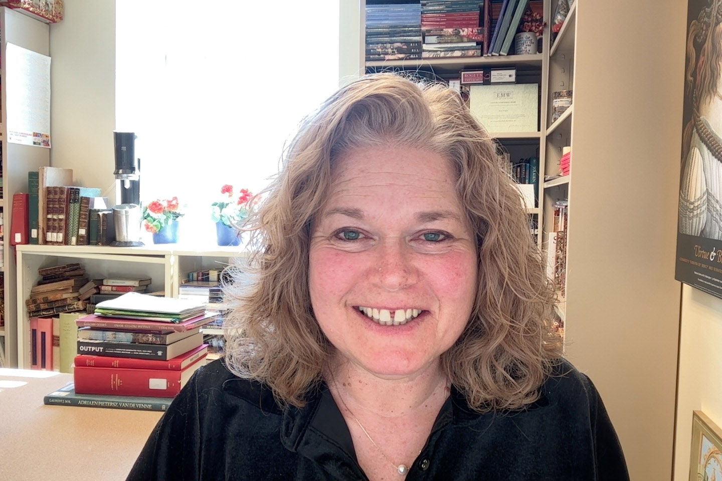 Woman in front of desk and bookcases